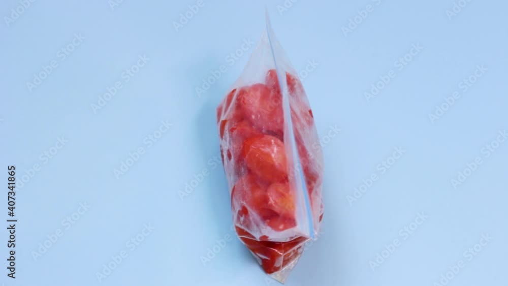 Female hands and packages of frozen vegetables on blue background top view. Female hands and packages of frozen vegetables on blue background top view.