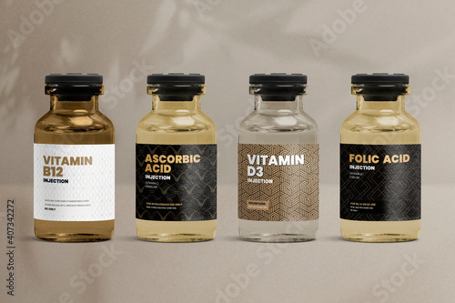Vitamin injection vial glass bottles with luxurious patterned labels photo