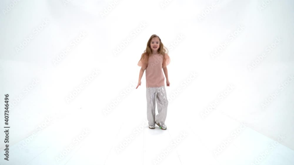 A cheerful little girl is dancing.The concept of a school of dance. A cheerful little girl is dancing.The concept of a school of dance.