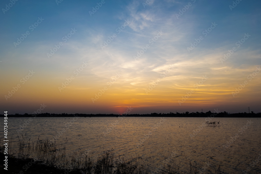 The sky at sunset, twilight colors beautifully with river or lake. Natural background The sky at sunset, twilight colors beautifully with river or lake. Natural background