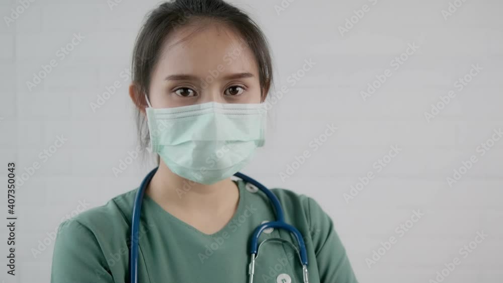 Asian female medical healthcare worker doctor nurse surgeon close up face, surgical face mask protection from coronavirus outbreak, strong confident professional specialist portrait white background
