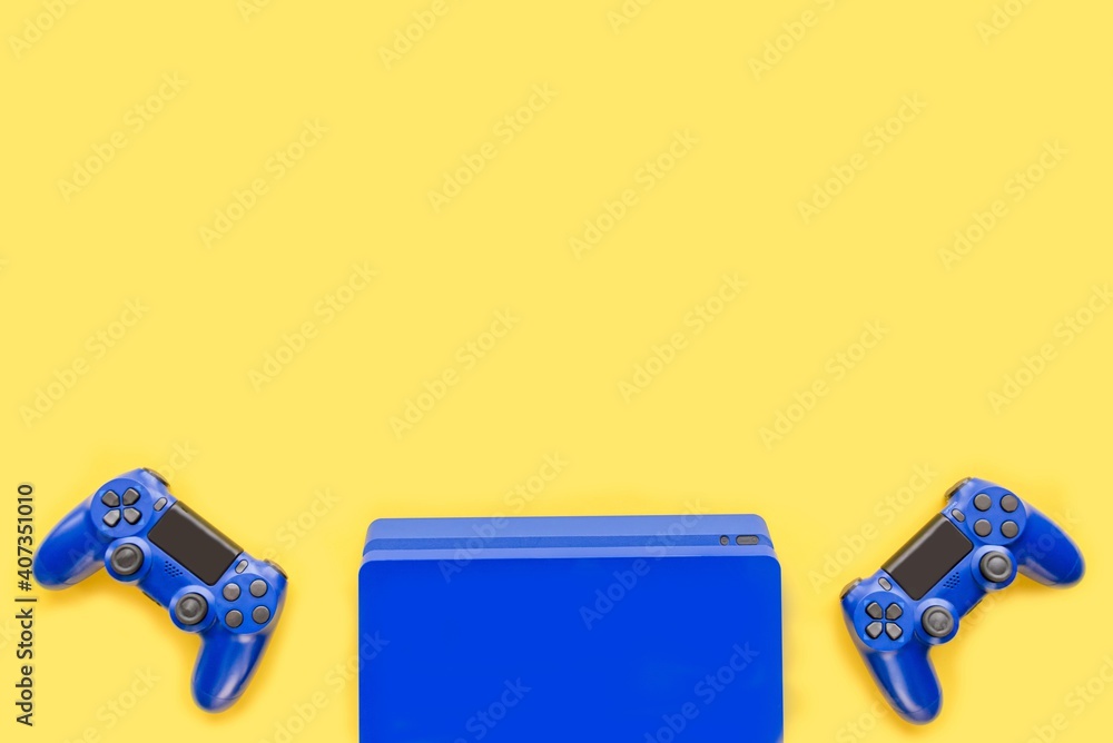 Top view of blue gaming controllers and console. Virtual regality gaming accessories.