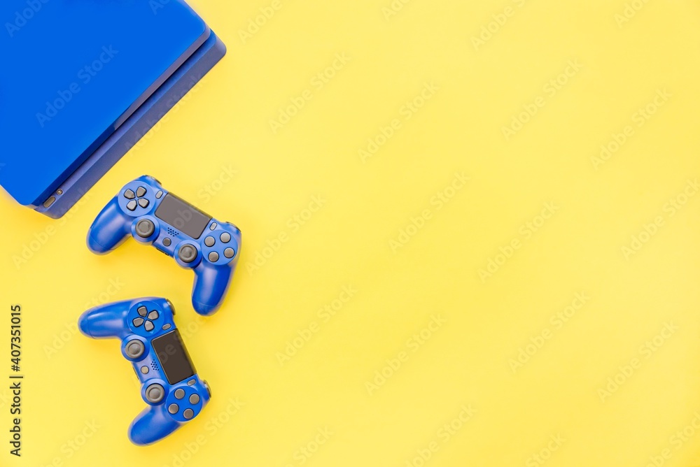 Top view of blue gaming controllers and console. Virtual regality gaming accessories.