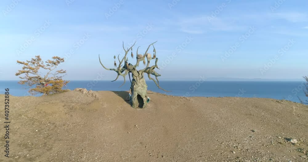 Iconic Landmark of Baikal Olkhon Island Famous Tourist Attraction - Baikal Keeper Tree Beautiful landscape Blue Lake Top view drone footage Iconic Landmark of Baikal Olkhon Island Famous Tourist Attraction - Baikal Keeper Tree Beautiful landscape Blue Lake Top view drone footage
