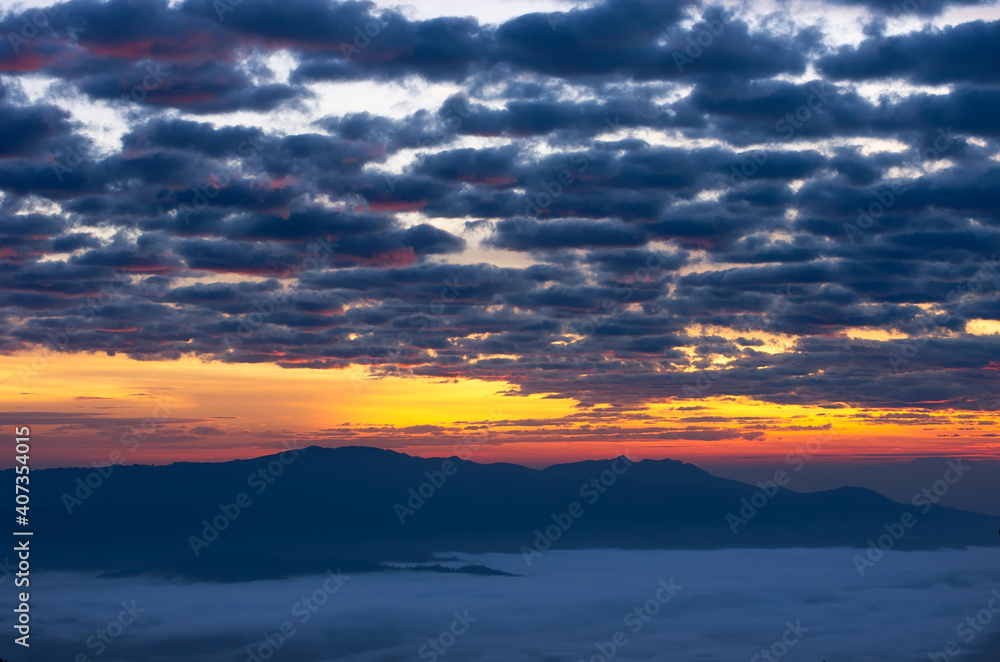 Beautiful fog over green forest on mountain with vivid sky, Aerial view sunrise over the mountain range at the north of thailand, Beauty rainforest landscape with fog in morning.