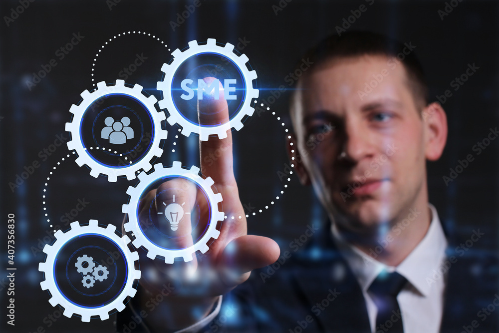 Business, Technology, Internet and network concept. Young businessman working on a virtual screen of the future and sees the inscription: SME Business, Technology, Internet and network concept. Young businessman working on a virtual screen of the future and sees the inscription: SME