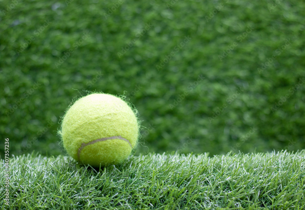 Tennis is on green grass background