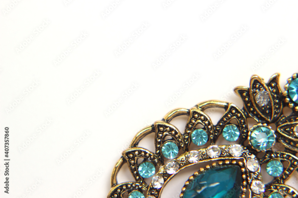 Oriental Turkish women's jewelry with blue gem on a white background