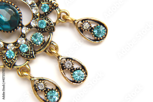 Oriental Turkish women's jewelry with blue gem on a white background