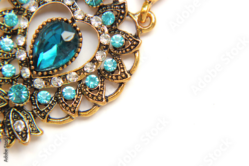 Oriental Turkish women's jewelry with blue gem on a white background