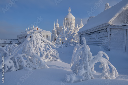Frozen trees and a church on a sunny day