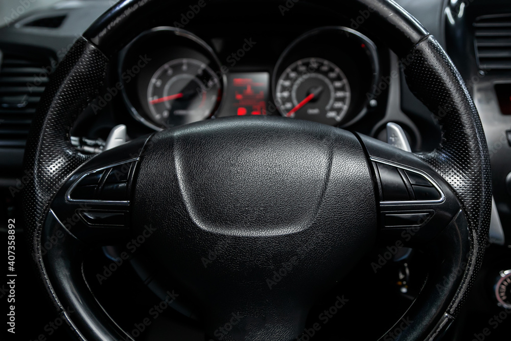 new car interior details. Speedometer, tachometer and steering wheel