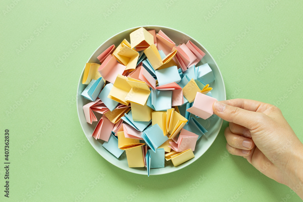 Draw lots. Folded colorful papers in bowl