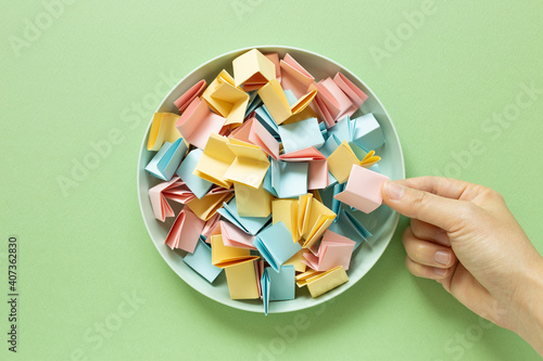 Obraz na płótnie Draw lots. Folded colorful papers in bowl w salonie
