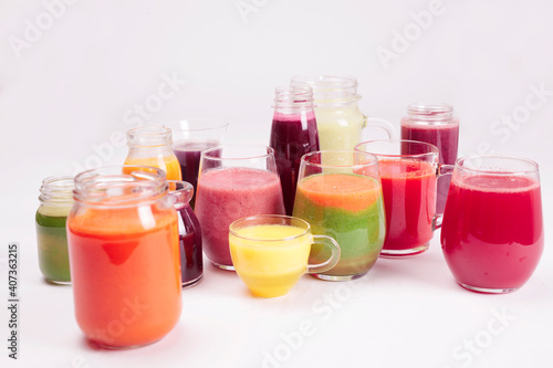 Glasses of fresh fruit juice isolated on white background