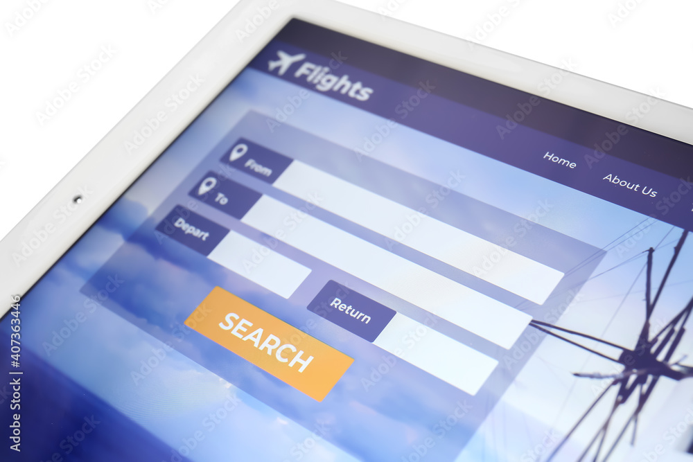 Open page of online booking service on screen of tablet computer, closeup Open page of online booking service on screen of tablet computer, closeup