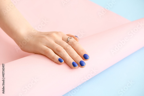 Hand with beautiful manicure on color background