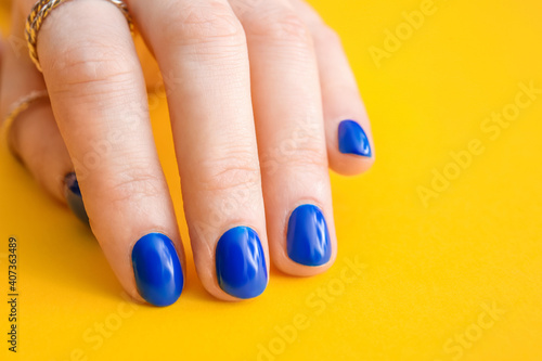Hand with beautiful manicure on color background, closeup