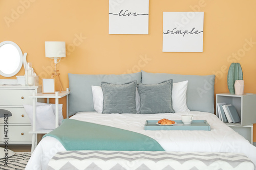 Stylish interior of bedroom with comfortable bed