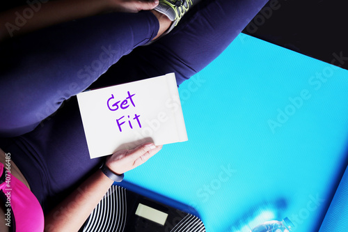 Cuadro en lienzo Top view of Healthy Lifestyle concept, Woman sitting on yoga mat with Get fit text