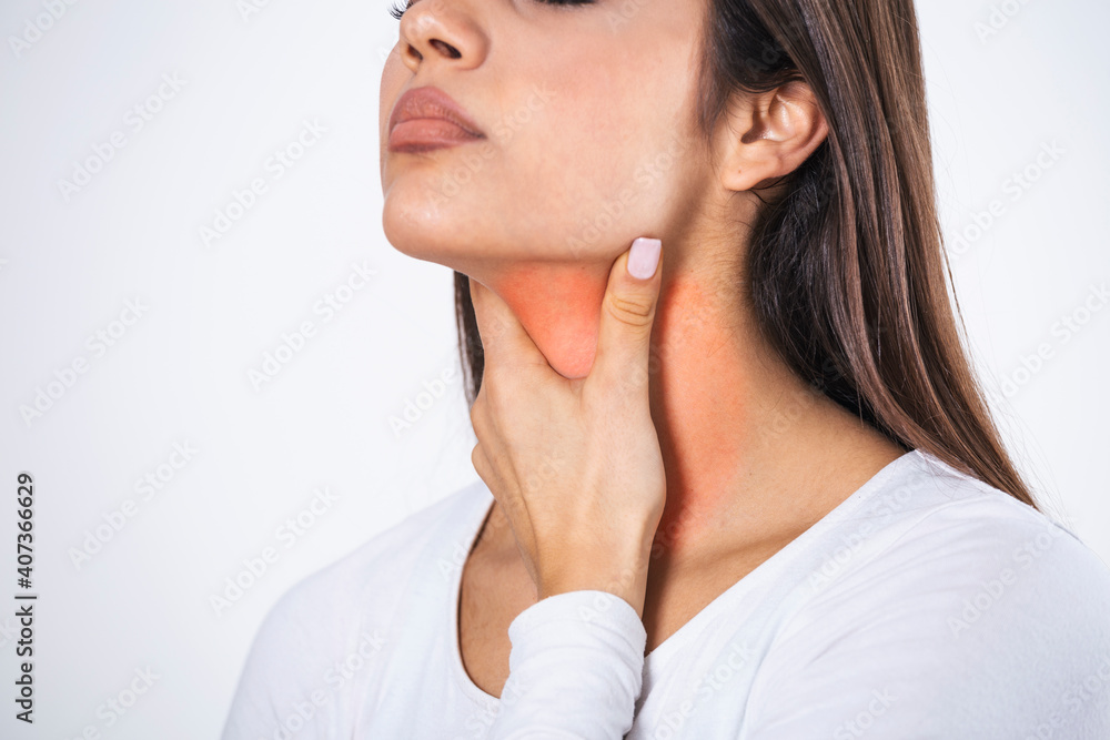 Young beautiful woman suffering from pain in throat, touching inflamed zone on her neck, cropped, empty space, sore throat Young beautiful woman suffering from pain in throat, touching inflamed zone on her neck, cropped, empty space, sore throat
