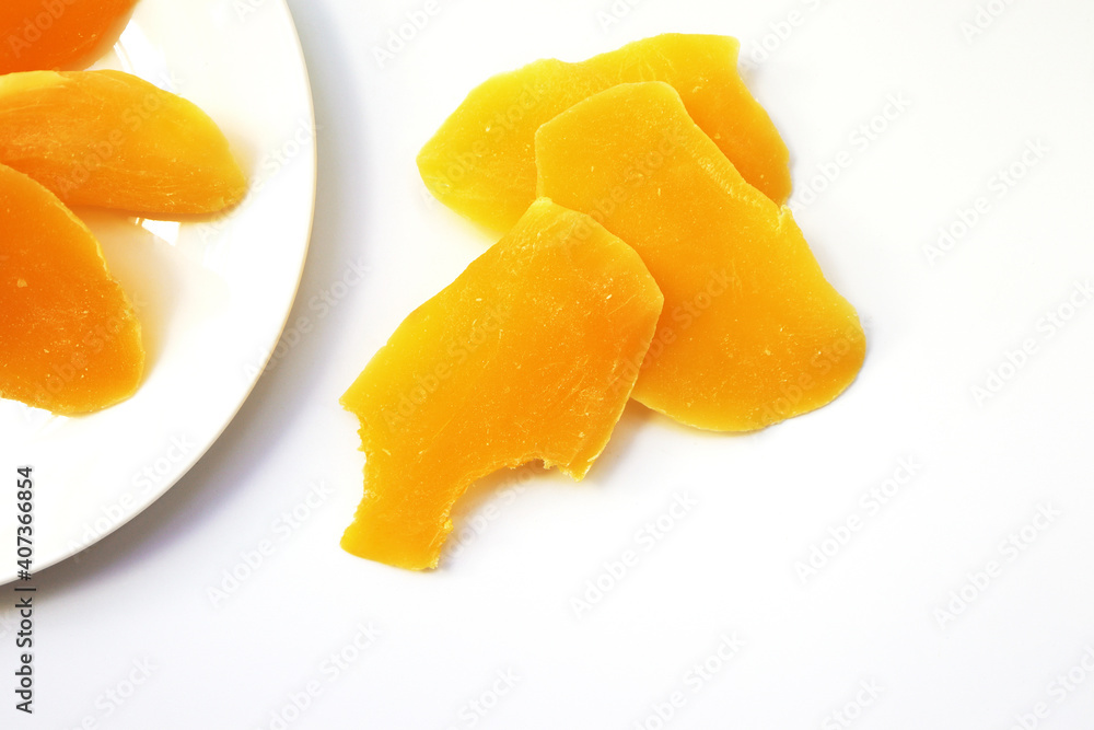 Sliced dried mango in white dish.