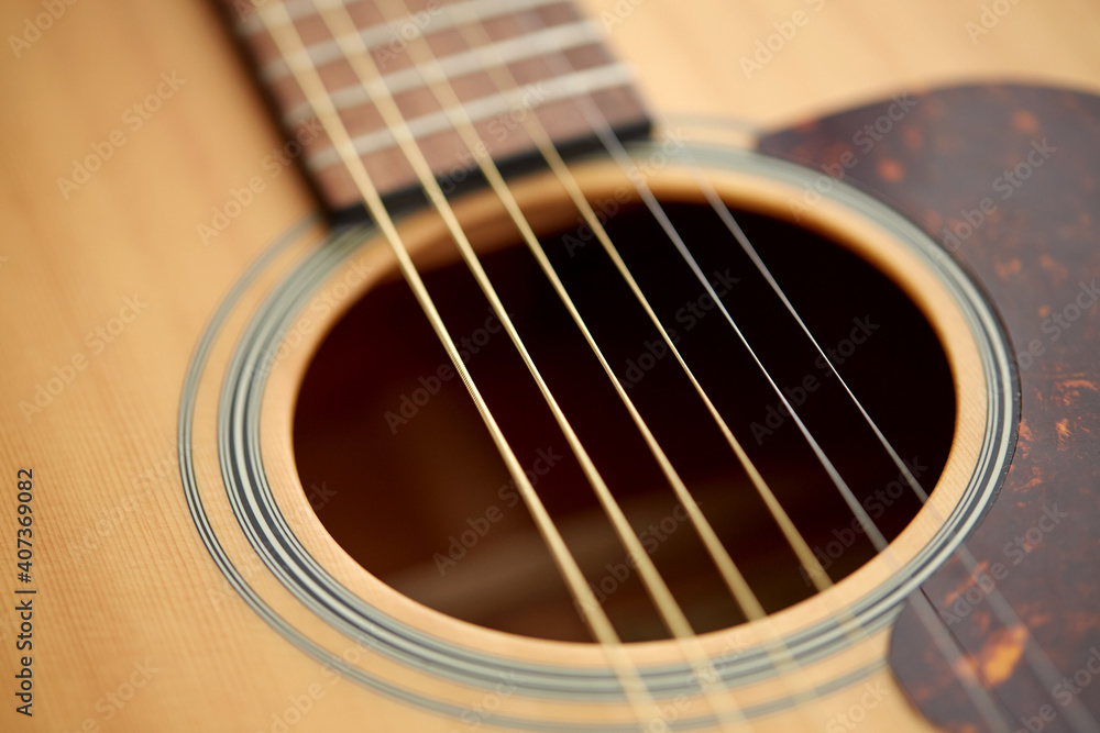 leisure, music and musical instruments concept - close up of acoustic guitar strings leisure, music and musical instruments concept - close up of acoustic guitar strings