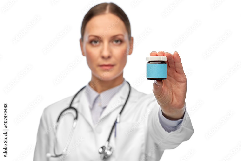 medicine and healthcare concept - close up of female doctor with stethoscope holding jar of pills over white background