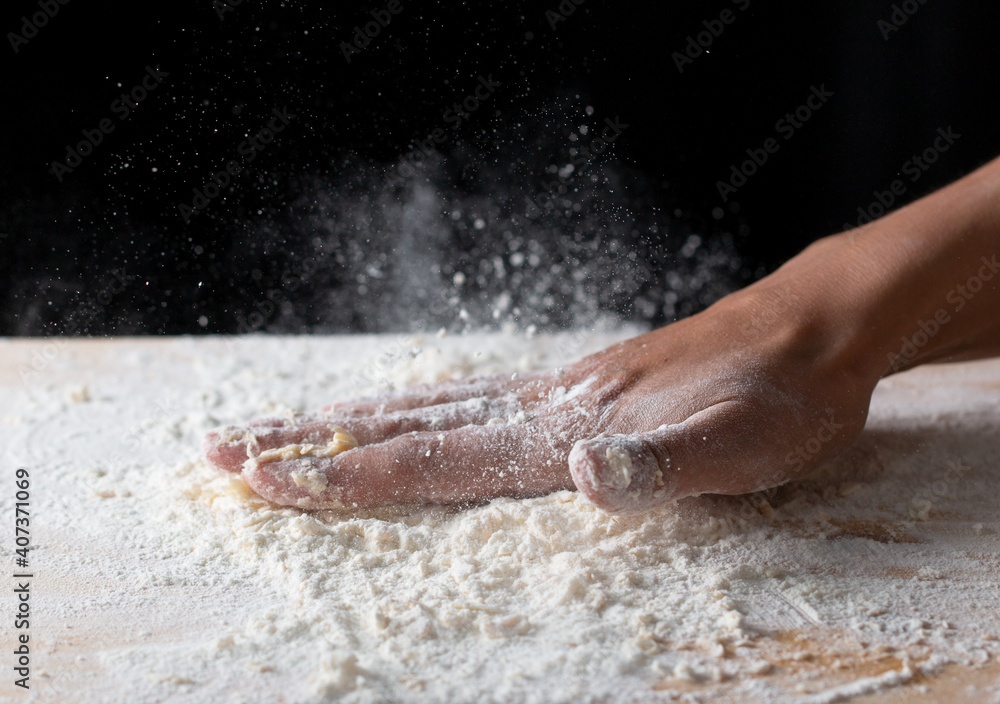 wave of hands with flour on a black background wave of hands with flour on a black background
