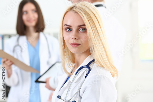 Beautiful smiling female doctor stand in office portrait. Physical and patient disease prevention, exam, er, ward round, 911, prescribe remedy, healthy lifestyle, consultant, nurse profession concept