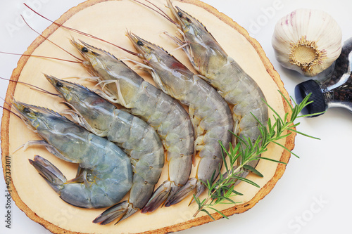 raw shrimps prawns with ingredients herb rosemary on white plate background