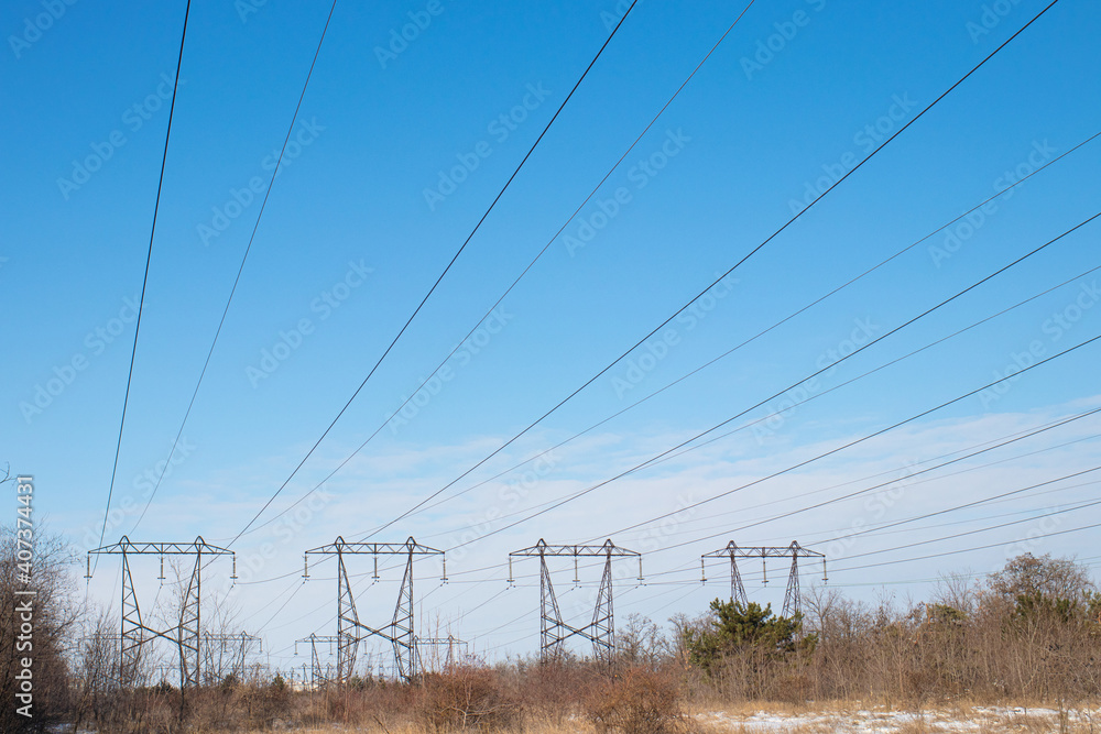 Electric wires and high voltage power lines on the background of sky and nature