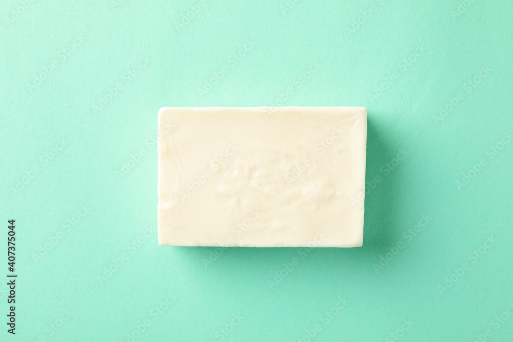 Piece of natural handmade soap on mint background - obrazy, fototapety, plakaty 
