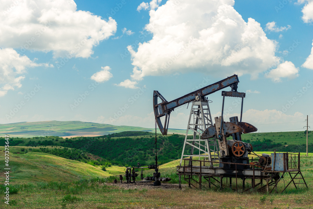 The pumping unit as the oil pump installed on a well. Equipment of oil fields. The pumping unit as the oil pump installed on a well. Equipment of oil fields.