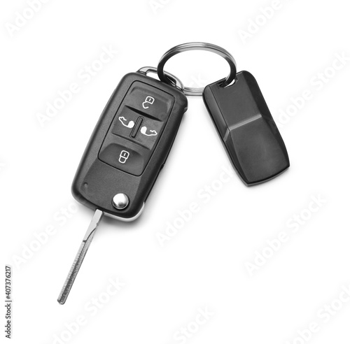 Modern car flip key with trinket isolated on white, top view