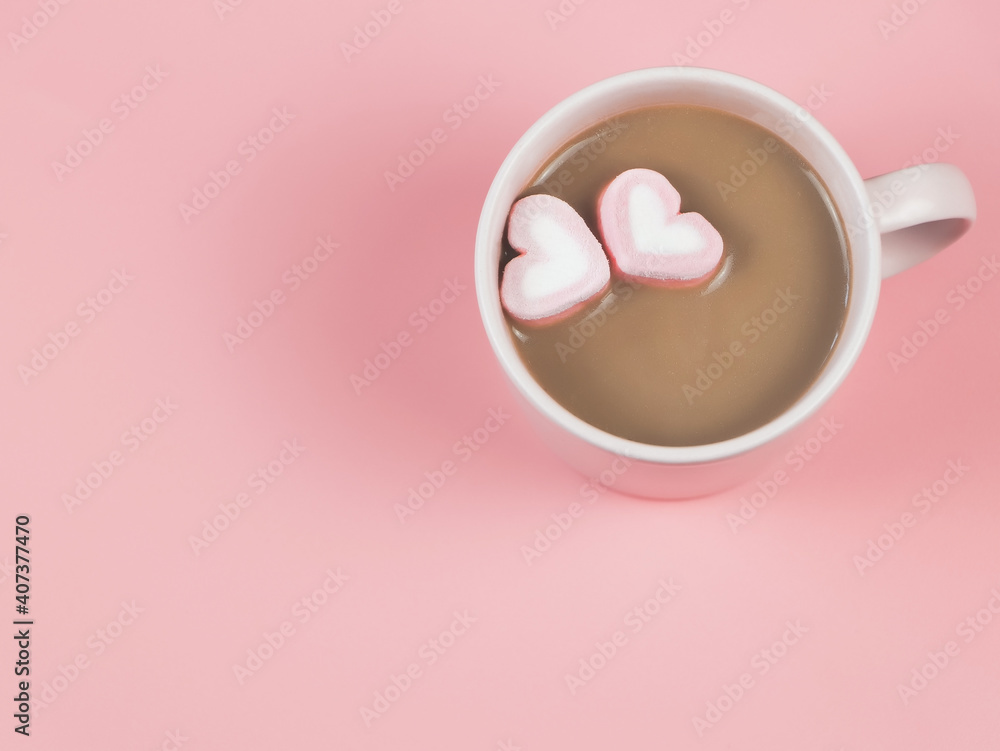 hot chocolate with two heart shape marshmallows on pink background with copy space. Valentine's day and beverage concept. hot chocolate with two heart shape marshmallows on pink background with copy space. Valentine's day and beverage concept.
