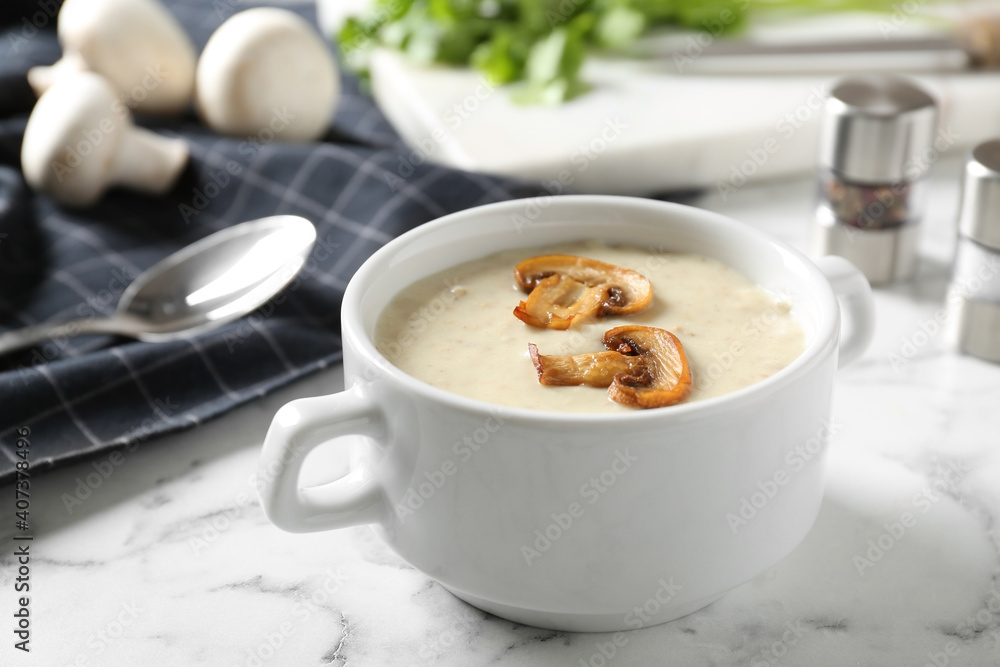 Delicious cream soup with mushrooms on white marble table Delicious cream soup with mushrooms on white marble table