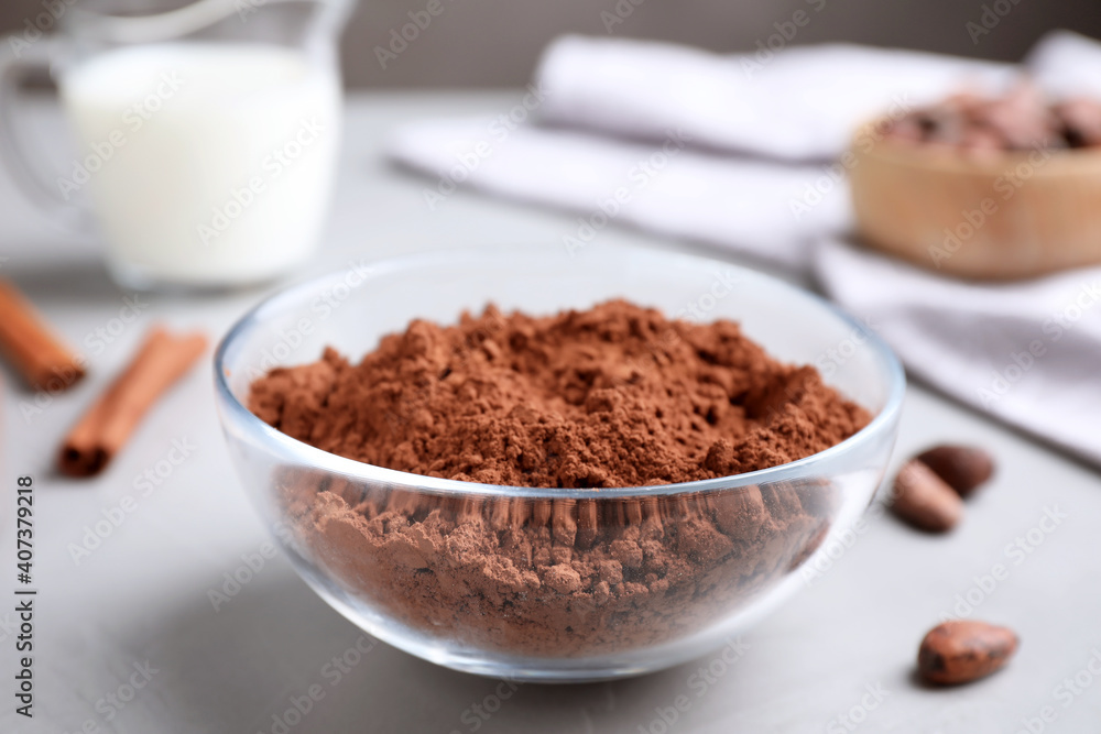 Cocoa powder in bowl on light table Cocoa powder in bowl on light table