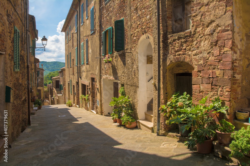 A quiet residential street in the historic centre of the medieval town of Monticiano in Siena Province, Tuscany, Italy 