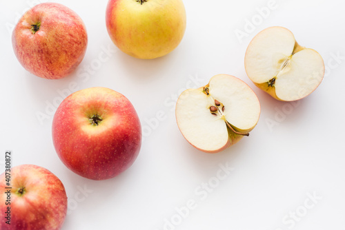 red apples on white background, halves of apples on a white background