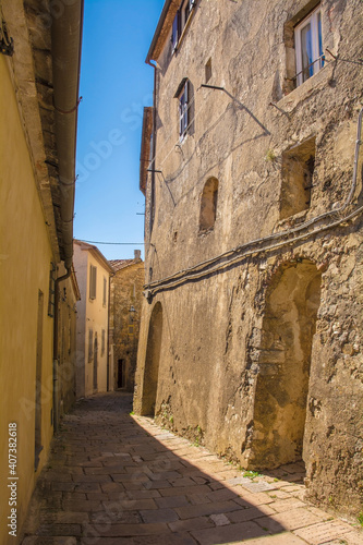 Fototapeta Naklejka Na Ścianę i Meble -  A residential street in the historic medieval village of Semproniano in Grosseto Province, Tuscany, Italy
