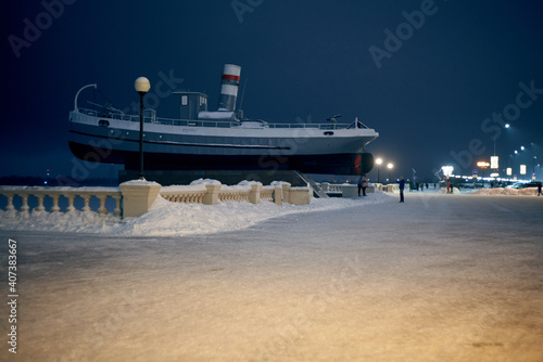 Nizhny Novgorod, Russia. January 5, 2021: Boat Hero is installed on the post at the foot of the Chkalovskaya staircase. Winter evening. photo