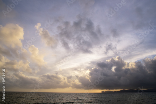 Panorama evening sky with blue, white and orange clouds near the sea