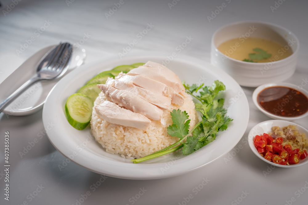 Hainanese chicken rice on a white table background, Steamed chicken rice with spicy sauces and chicken soup, Hainanese chicken rice on a white table background, Steamed chicken rice with spicy sauces and chicken soup,