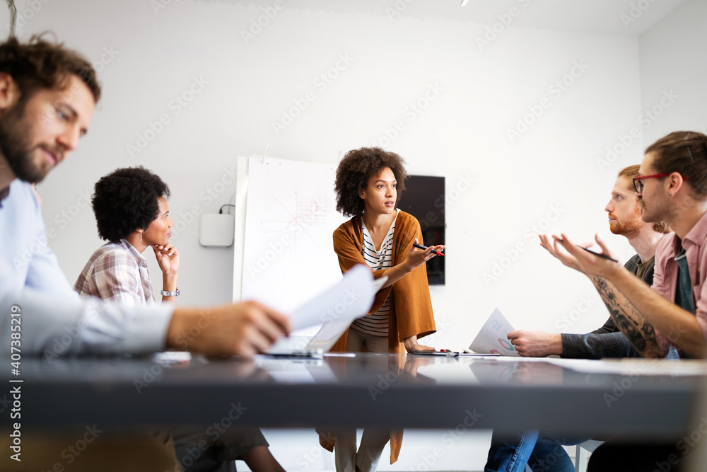 Fototapeta premium Cheerful coworkers in office during company meeting