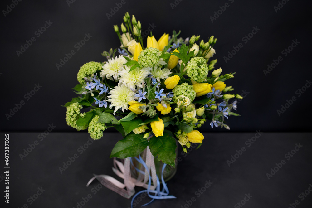 A bouquet of bright, juicy flowers on a dark background. Spiral assembly technique without decorative packaging.