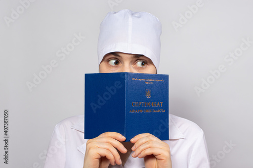 Obraz na plátně Doctor holds a diploma of higher education, a certificate of professional develo
