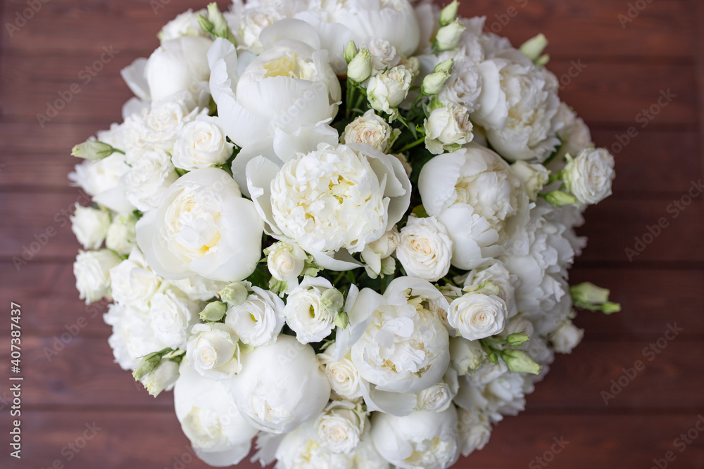 White peonies collected in a composition. Fresh, natural flowers, on a dark background White peonies collected in a composition. Fresh, natural flowers, on a dark background