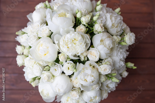 White peonies collected in a composition. Fresh  natural flowers  on a dark background