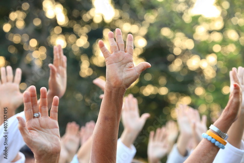 People raise their hands up for protest and uprising in demonstration event for unity and unanimous vote concept photo